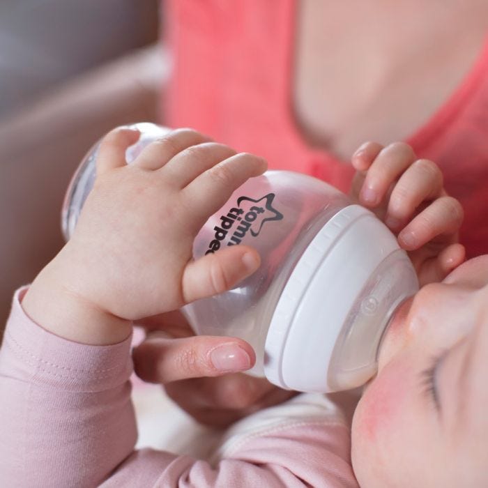 Baby with bottle in hands