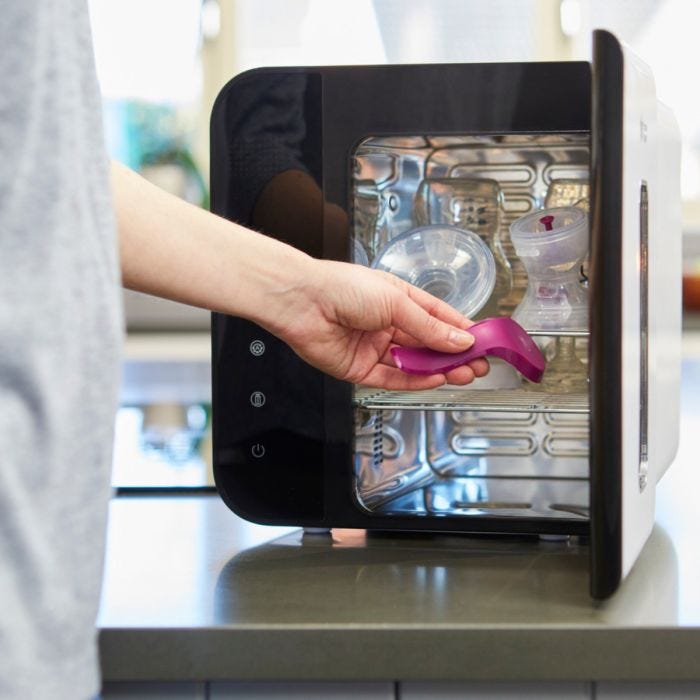 Tommee Tippee Ultra UV 3-in-1 Steriliser, Dryer and Storage open with hand 