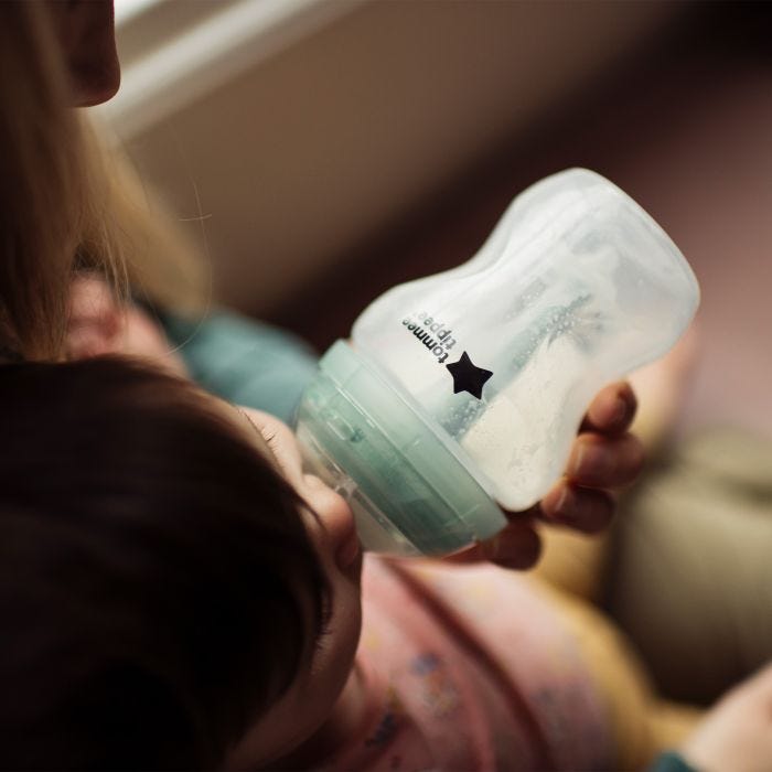 Aerial view of baby drinking milk from Advanced Anti-Colic bottle