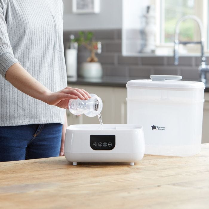 Mom pouring water into Advanced Electric Steri-dryer 