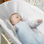 Baby wearing blue marl snuggee in moses basket