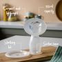 Silicone breast pump and sterilising lid on kitchen counter with pointers of its best features