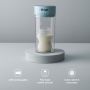Colicsoothe on a plinth on a grey background with a bottle of milk inside with roundels highlighting key features