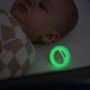 Baby sleeping with glowing in the dark soother next to them