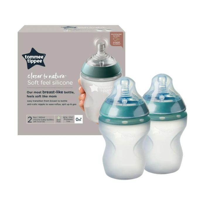 2x 9oz silicone baby bottles next to packaging on white background.