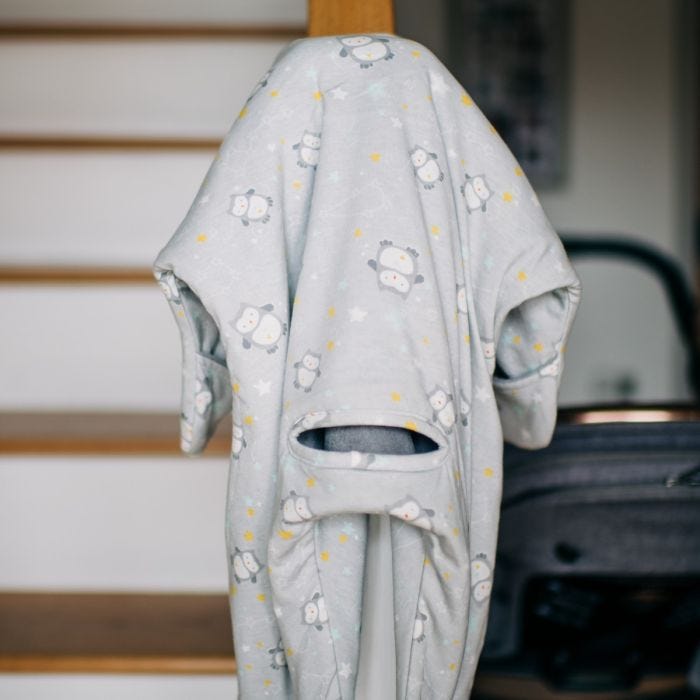 Ollie the Owl Starsuit™ Pram Suit hanging from stair post