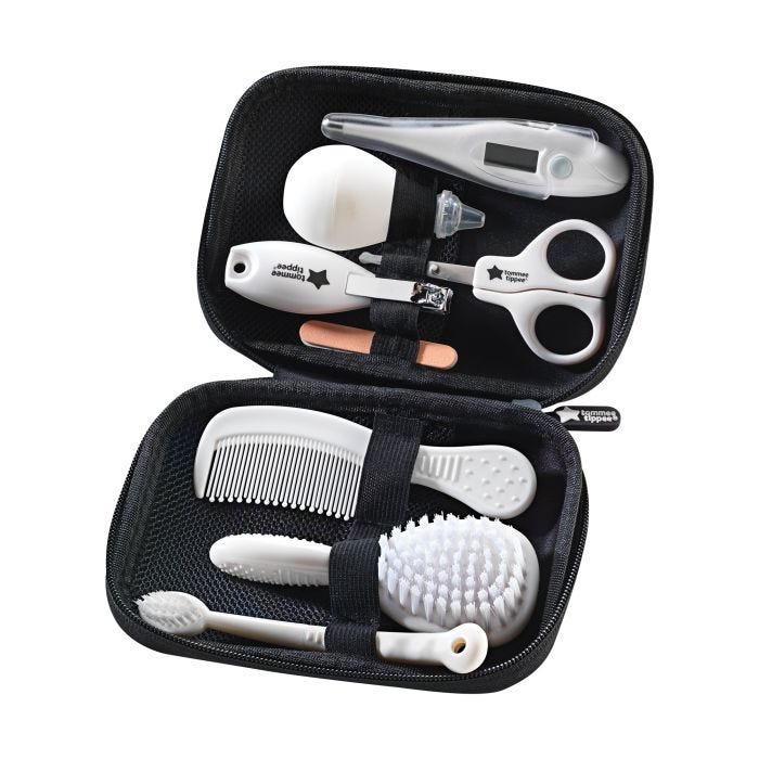 Healthcare kit items including hair and nailcare acessories in the open black travel case on a white background.