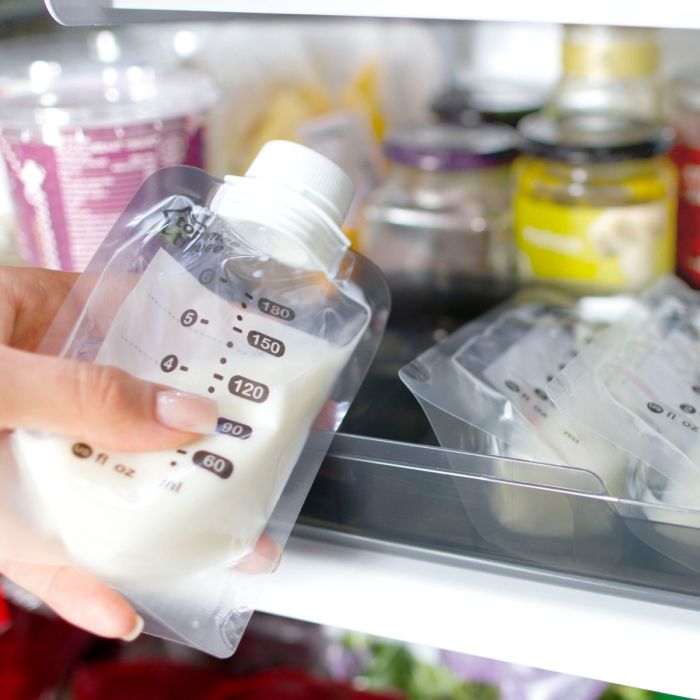 mum placing milk pouch into fridge