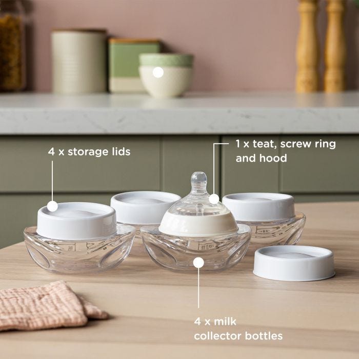 Wearable breast pump with four milk collector bottles on a kitchen table