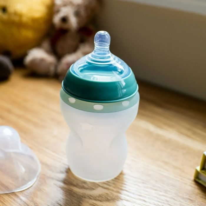 silicone baby bottle on wooden table.