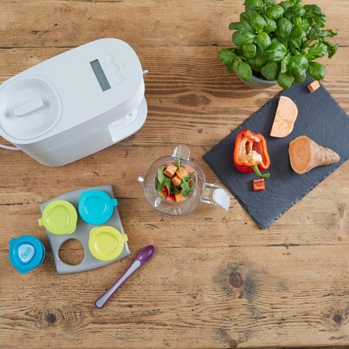 top-down-shot-of-quick-cook-baby-food-maker-with-a-range-of-fresh-cooking-ingredients-on-a-chopping-board-including-sweet-potato-and-pepper