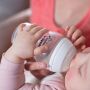Baby with bottle in hands