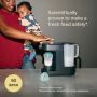 Image of a woman holding a toddler and using a Perfect Prep machine to make a feed with text overlay of product feature