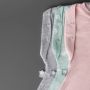 Three folded sleeping bags on a grey background