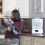 Mom feeding baby with Advanced Electric Steri-dryer in the background