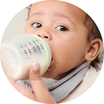 A mum using a tommee tippee nappy disposal bin